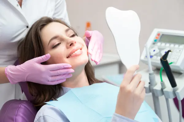 dentist-framing-patient-smile-with-gloved-hands